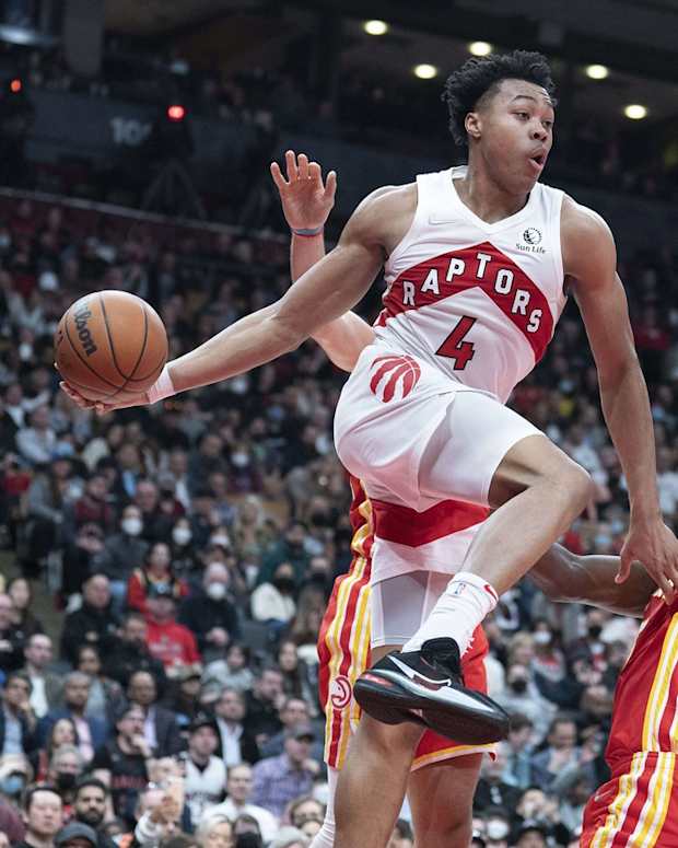 Apr 5, 2022; Toronto, Ontario, CAN; Toronto Raptors forward Scottie Barnes (4) controls the ball as Atlanta Hawks center Clint Capela (15) tries to defend during the fourth quarter at Scotiabank Arena. Mandatory Credit: Nick Turchiaro-USA TODAY Sports